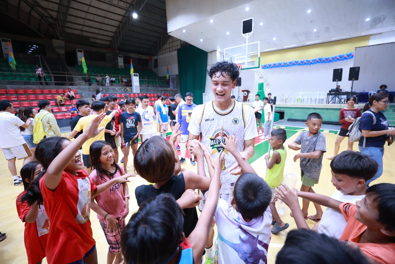 Darrell Cenido celebrating with kids on the basketball court