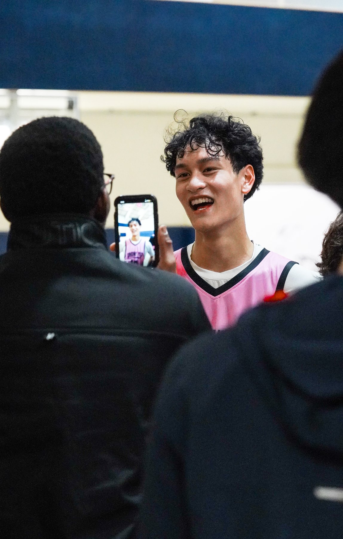 Darrell Cenido laughing with friends in a candid basketball moment